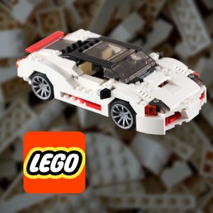 LEGO logo med klossar i bakgrund och vit legobil fram